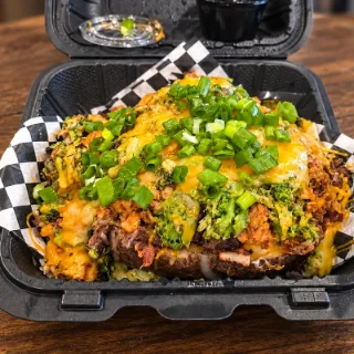 The OverFlo loaded baked potato topped with steak, chicken, bacon and broccoli