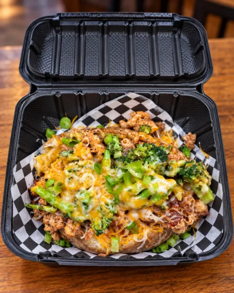 Loaded baked potato with chicken, broccoli, melted cheddar and green onions