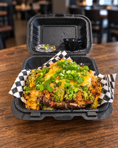 The OverFlo loaded baked potato with steak, chicken, bacon, broccoli and green onions