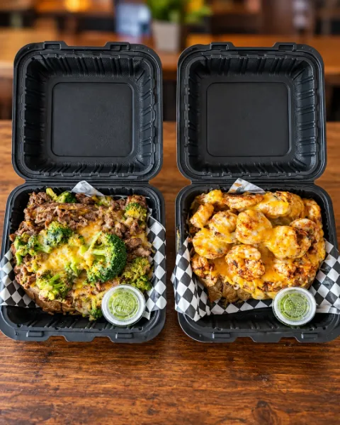 Two OverFlo Potato takeout boxes side by side: steak with broccoli and shrimp with cheese